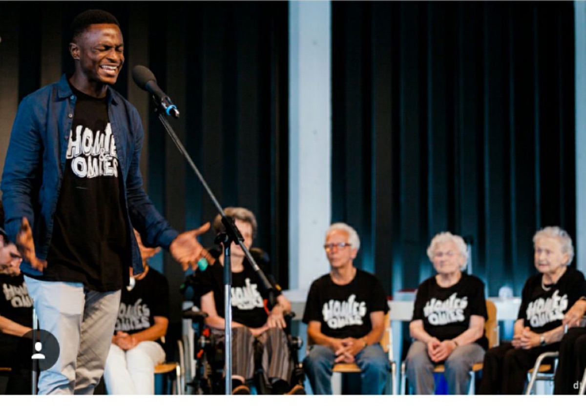 Adetayo on stage with senior performers of the One Community Gala